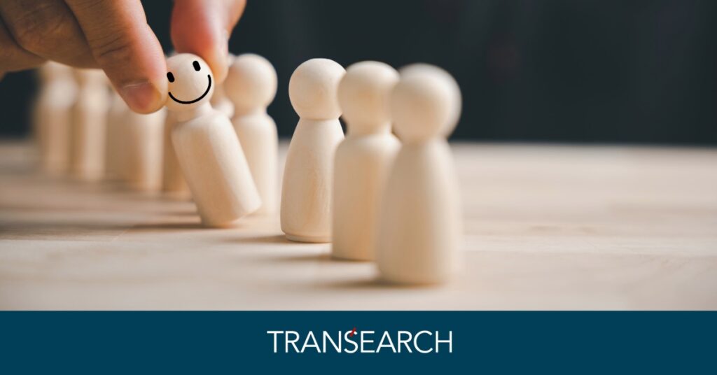 A person picking one out of a set of human like wooden figures